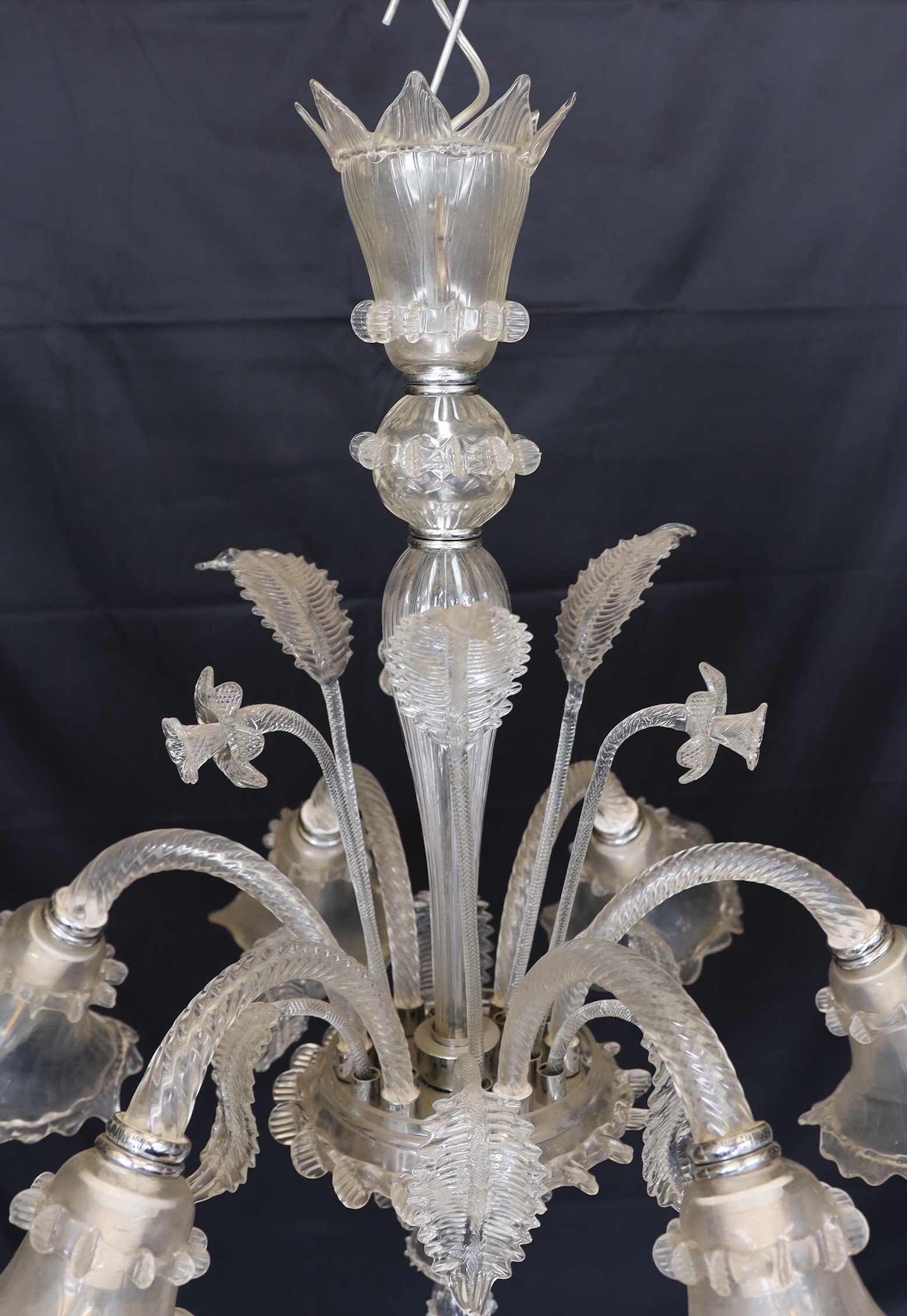 A Venetian clear glass six light chandelier with ornate foliage and flower motifs, height 85cm. width 74cm